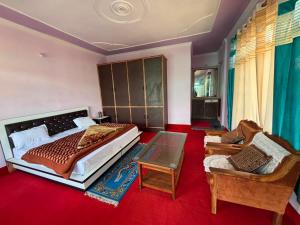 a bedroom with a large bed and a couch at Alpine Homestay in Joshīmath