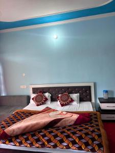 a bedroom with a large bed with a large headboard at Alpine Homestay in Joshīmath