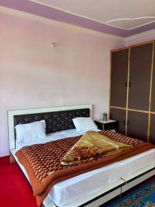 a bedroom with a large bed in a room at Alpine Homestay in Joshīmath