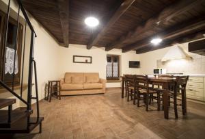 a living room with a couch and a table and chairs at Agriturismo La Filomena in Montefortino