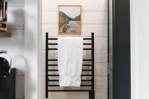 a towel hanging on a towel rack in a bathroom at Luxury tiny cottage with deck hammock and hot tub! in Guntersville