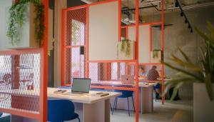an office with two desks and a laptop computer at Homaris K48 Studios in Berlin