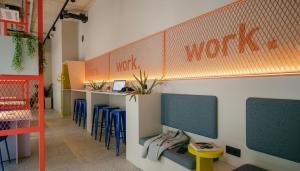 a waiting room with blue chairs and a work counter at Homaris K48 Studios in Berlin