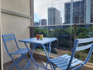 a blue table and two chairs on a balcony at Ande Tower, Batumi in Minda