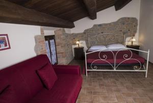 a living room with a bed and a couch at Agriturismo La Filomena in Montefortino +36 photos