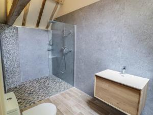 a bathroom with a shower with a sink and a toilet at Netherend Barn in Colwall