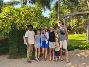 a family posing for a picture in a park at BG Guest House Jaffna in Tirunelveli East