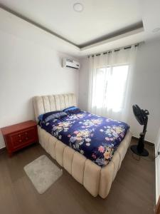 a bedroom with a bed and a window at Maisonette near Alpha Beach in Ibeju