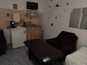 a small kitchen with a couch and a sink at Стая за гости При Валко in Belogradchik +13 photos