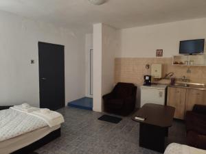 a hotel room with a bed and a kitchen at Стая за гости При Валко in Belogradchik