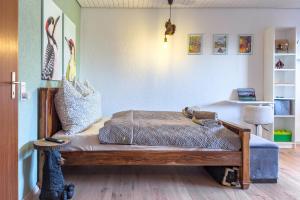 a room with a bed with a wooden bench at Am Silberbergblick in Bodenmais