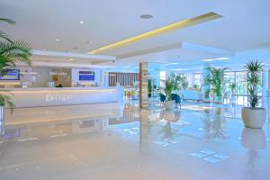 a lobby with potted plants in a building at Alfagar Prestige in Albufeira +42 photos