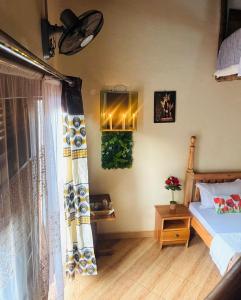 a bedroom with a bed and a window at Eagle Nest in Namulanda