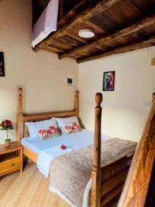a bedroom with a bed with a wooden frame at Eagle Nest in Namulanda