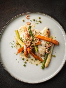 a plate of food with shrimp and vegetables on it at ‘t Ziltebos in Wenduine