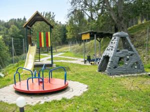 a playground with two slides and a play structure at Ferienhaus Huber in Bleiburg +29 photos