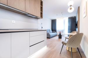 a kitchen and living room with a table and chairs at MCK Apartments in Košice