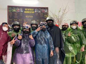 a group of people in rain gear posing for a picture at Tam coc Newway Homestay in Ninh Binh +24 photos