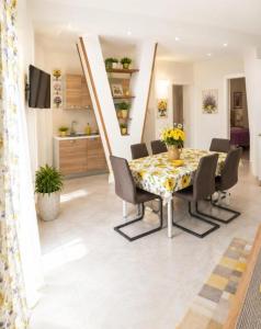 a dining room with a table and chairs at Villa Blu Dea room & apartment in Torre Lapillo