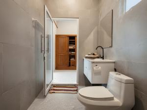 a bathroom with a toilet and a sink at Villa Monroe - Elegant Private Pool Villa in Ban Nok