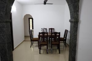 a dining room with a table and chairs at Casa Inn Homestay in Munnar
