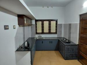 a kitchen with a sink and a counter top at Casa Inn Homestay in Munnar