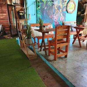 a wooden table and chairs in a room at El Puente in El Paredón Buena Vista