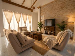 a living room with two couches and a television at Villa Monroe - Elegant Private Pool Villa in Ban Nok