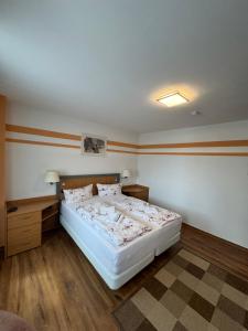 a bedroom with a white bed in a room at Hellwig Ferienwohnung 1 in Bernburg