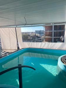 a swimming pool with a view of a city at plaza hotel in Termas de Río Hondo
