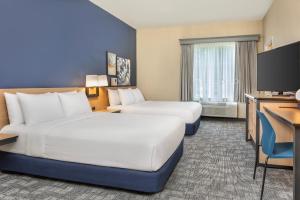 a hotel room with two beds and a desk at City Express by Marriott Elkridge in Elkridge +59 photos
