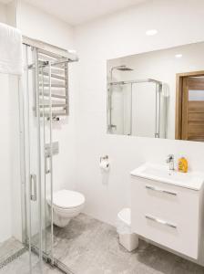 a white bathroom with a toilet and a sink at Willa Agnieszki in Jagniątków +104 photos