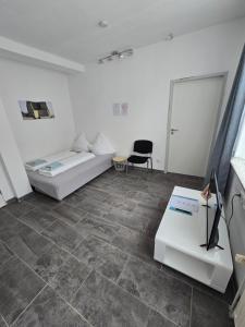 a living room with a couch and a table at Holidayapartment Bella Napoli in Liblar