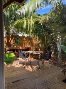 a table and chairs sitting on a wooden deck at Tiny du lagon in Saint-Paul +20 photos