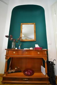a mirror sitting on top of a wooden table at Studio MAYA in Maribor