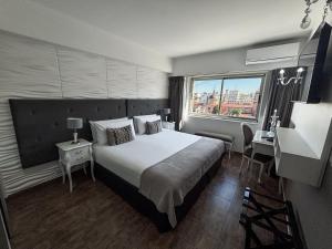 a hotel room with a large bed and a window at Ker San Telmo Hotel in Buenos Aires