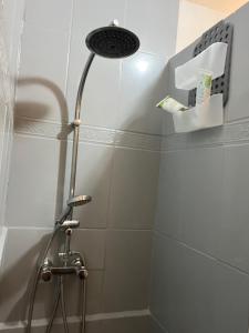 a shower with a shower head in a bathroom at lagon studio ermitage in Saint-Paul +23 photos
