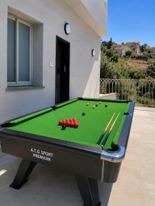 a pool table in front of a house at שושנת מטולה in Metulla