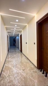 a corridor of an office building with water on the floor at Hotel Del Luna in Greater Noida