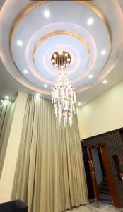 a ceiling with a chandelier in a room at Hotel Del Luna in Greater Noida +2 photos