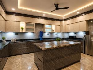 a large kitchen with a large island in the middle at Hotel Del Luna in Greater Noida
