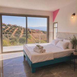 a bedroom with a large bed with a large window at שושנת מטולה in Metulla