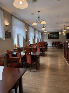 a dining room with wooden tables and chairs at Willa Agnieszki in Jagniątków