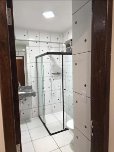 a bathroom with a glass shower and a toilet at Apto com 2 quartos e A/C no Centro in Montes Claros +21 photos