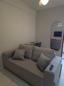 a living room with a couch and a tv at Apto com 2 quartos e A/C no Centro in Montes Claros
