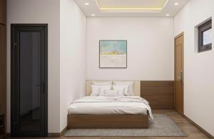 a bedroom with a bed in a white wall at Eco House Cat Ba in Hai Phong