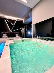 a large swimming pool in a hotel room at HeySuite Trastevere GuestHouse ROMA in Rome +8 photos