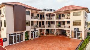 an apartment building with a red brick courtyard at MAAT Luxury Homes in Accra