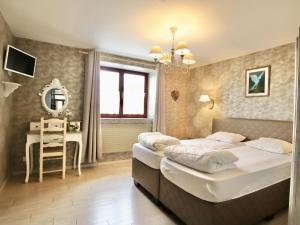 a bedroom with a bed and a desk in it at Ferme de la Galoperie in Couvin