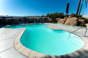 a large pool with blue water in a resort at The Grove at Pismo Beach in Pismo Beach